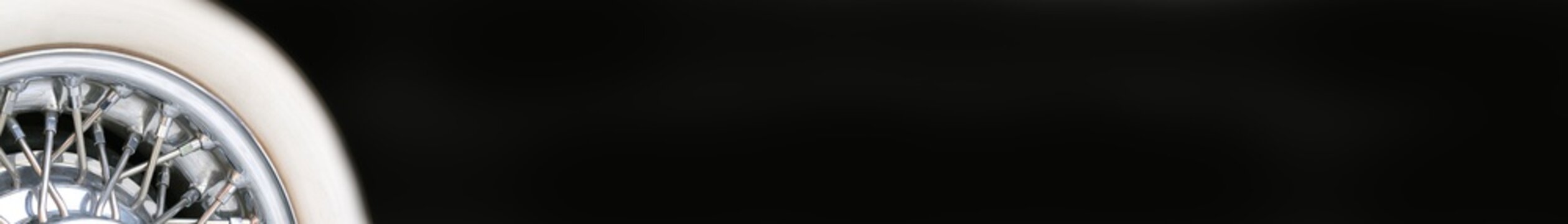 Luxury Car Wheel on a left side of black horizontal banner.