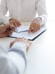  Businessmen make dollar payments while signing an investment agreement to be a partner in an...