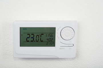 Modern heat thermostat on a white background