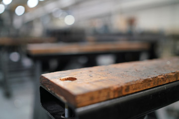 Fototapeta na wymiar Brown wooden work bench in a warehouse setting 