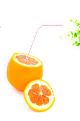 The cut orange has a straw in it on a white background