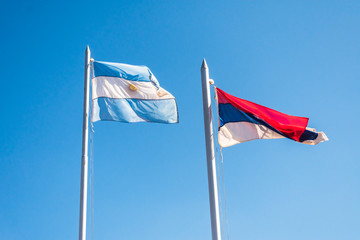 Flags of Argentina and Misiones Province against blue sky - Comandante Andresito, Argentina