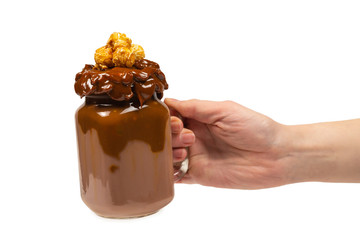 Chocolate milkshake with whipped cream, cookies, waffles, served in glass mason jar. 