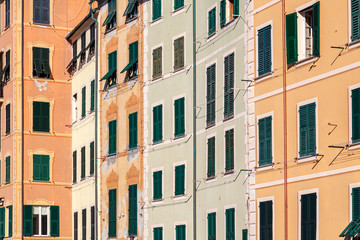 Fototapeta na wymiar Group of palaces facades of Camogli, painted with famous pastel colors. Camogli is a small fisherman village on the shores of the Ligurian Sea. (Northern Italy).