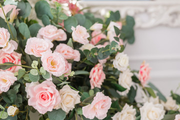 Floral arrangement with delicate roses. Wedding and holiday decor with pink and white roses. The concept of wedding and holidays.