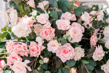 Floral arrangement with delicate roses. Wedding and holiday decor with pink and white roses. The concept of wedding and holidays.