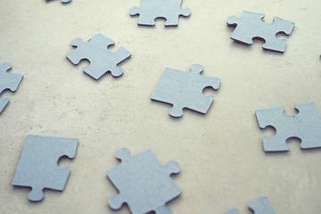 puzzle pieces on concrete dackground, selective focus