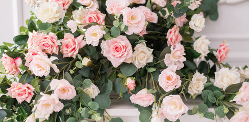 Obraz na płótnie Canvas Floral arrangement with delicate roses. Wedding and holiday decor with pink and white roses. The concept of wedding and holidays.