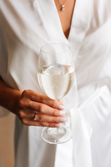 Closeup of bride holding a glass of champagne in her hand