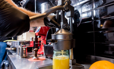 Metal manual juicer. Preparation of freshly squeezed orange juice