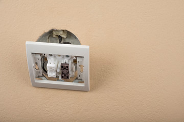 White electric switch with on a wall and without cover