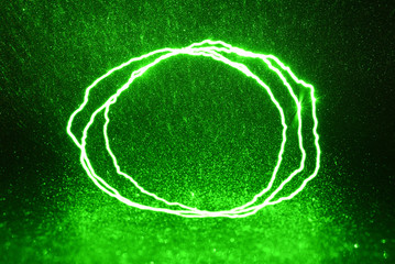 Green rays, lightning and glitter on a black background