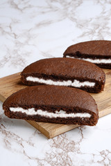 chocolate cream cake slices on cutting board