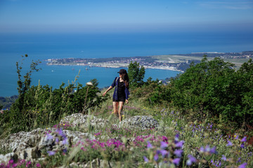 The girl enjoys being alone in nature. Spring Gelendzhik.