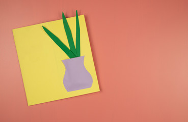 greeting card made by a child lies on a pink background
