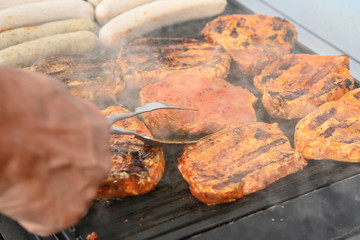 Barbecue grill bbq on coal charcoal grill with steaks bratwurst sausages and meat delicious summer meal