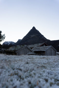 Winter picture of Norway's most beautiful  mountain valley Innerdalen. Traditional wooden farmhouses with grassy roof and hoarfrost. Amazing mountains around. Perfect place for outdoor activities.