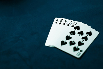Royal flush of spades. Winning poker hand on a dark table. Poker game concept