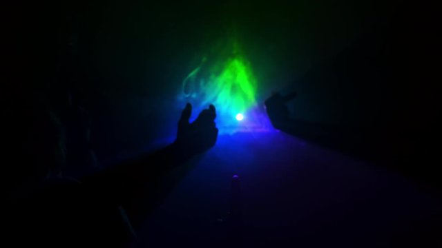 Symbolic Connection Of Three Hands Of Different People In Multicolored Rays Of Light.