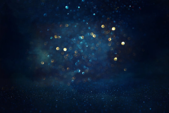 abstract glitter black, gold and blue lights background. de-focused