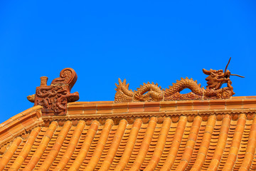 Fototapeta na wymiar Glazed tile Dragon carving in a temple, China