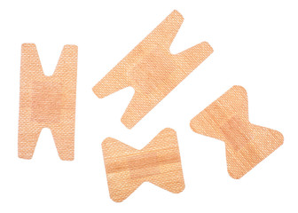 Set of adhesive plasters isolated on a white background, top view.