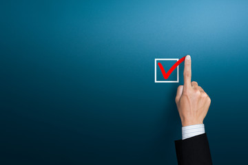 Checklist concept, Hand of businessman checking mark on the check boxes with marker red, copy space