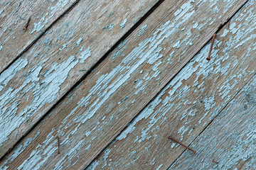 Blue vintage wooden board with rusty hobnails. fence background