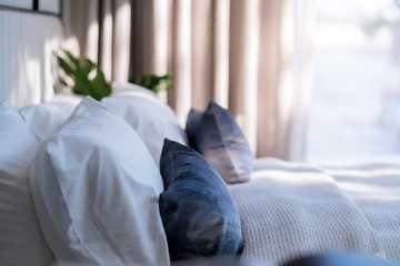 Bed maid-up with clean white pillows and bed sheets in beauty bedroom. Close-up. interior background