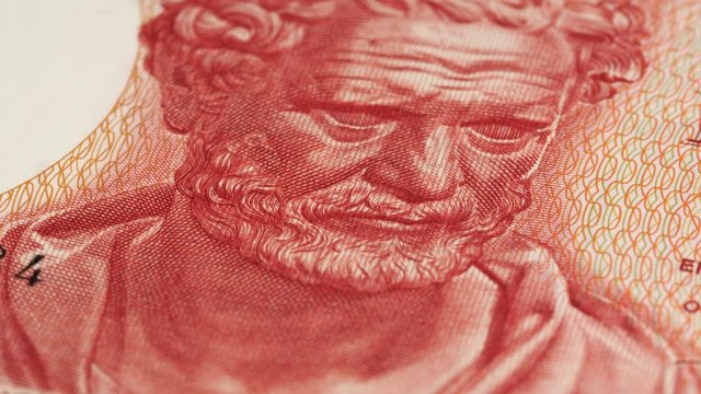 Democritus portrait on 100 Greece drachma (1967) banknote rotating. Famous ancient Greek philosopher. Low angle, macro. 4K, 422 10 bit