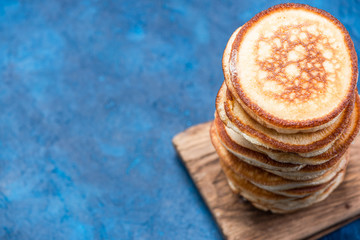Stack of Pancakes on Wooden Board. Overhead View. Border Background