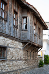 Fototapeta na wymiar Old Town of Nesebar. Authentic wooden facade of a Bulgarian house. ground floor made of stone