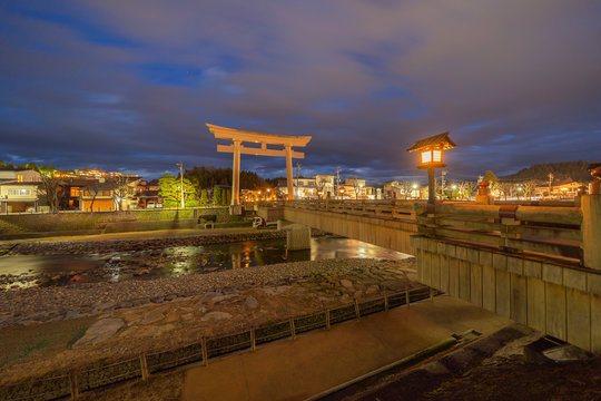 Japanese Torii pole at Miyamae Bridge at night in Takayama old town, Gifu, urban city in Japan. Architecture background.