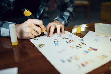 Maniac kidnapper hands cuts out letters