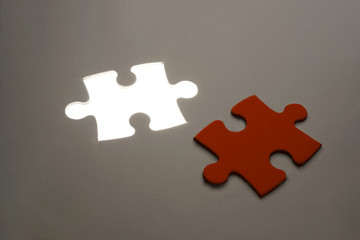 Red Missing jigsaw puzzle piece with light glow, business concept for completing the final puzzle piece