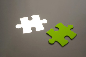 Green Missing jigsaw puzzle piece with light glow, business concept for completing the final puzzle piece