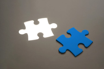 Blue Missing jigsaw puzzle piece with light glow, business concept for completing the final puzzle piece