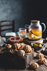 Tasty cakes with Hot tea with slices of fresh grapefruit on wooden tablet. Healthy drink, Eco, vegan