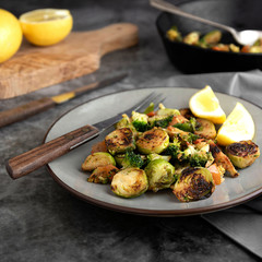 Roasted brussels sprouts portion. Healthy, homemade vegan food or loose weight. Dark background, square image