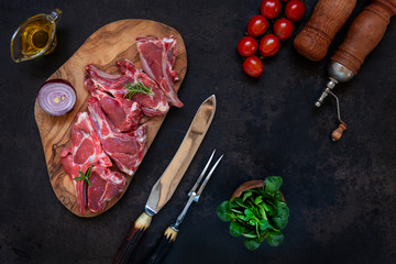 Raw fresh Lamb Meat ribs and seasonings on dark background