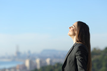 Profile of a businesswoman breathing fresh air