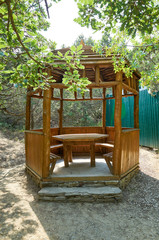 Fototapeta na wymiar Wooden arbor for rest in the botanical reserve Novyi Svit, Crimea