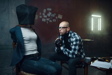 Maniac kidnapper looks on his female victim