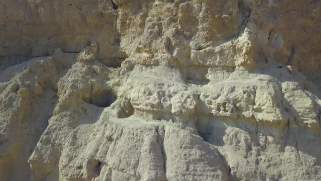 Khorbas Cave complex is located on the southern coast of the island of Keshm, Iran.The drone makes a video flying from the bottom up.You can see the caves in the rock, the fence. 