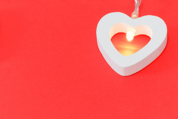 garland of hearts on a red background for Valentine's day with a place to copy