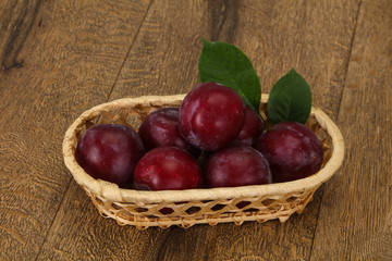 Plum heap in the wooden basket