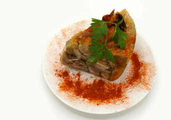 Traditional Romanian homemade pork trotter jelly dish called piftie. Jellied pork aspic made with pork meat served with paprika and fresh parsley.