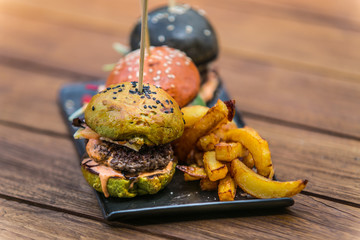 Sandwich hamburger with and mix of vegetables. Fast food. Delicious hamburger. Hamburger and french fries