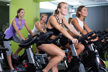 Fototapeta na wymiar Women cycling in fitness center