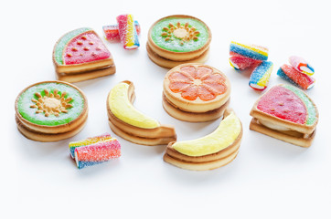 Different types of sweet shortbread cookies with fruit jelly on a white background